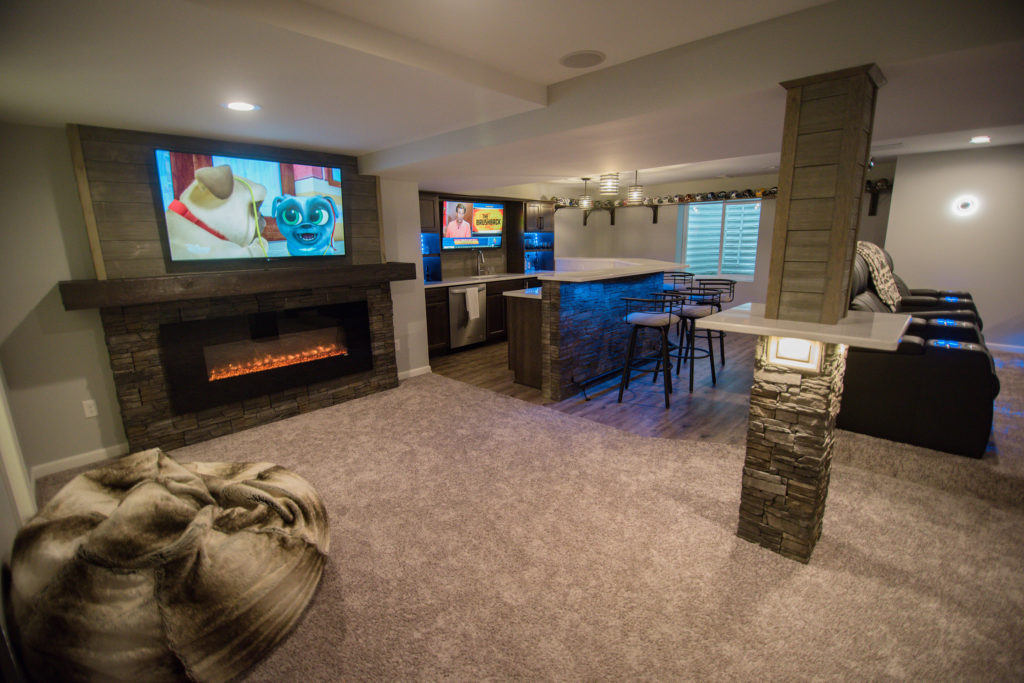 finished basement with carpet and vinyl plank flooring
