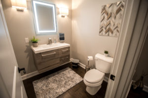 bright and modern industrial basement bathroom with floating vanity