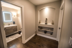 shelving niche in hallway to basement bathroom