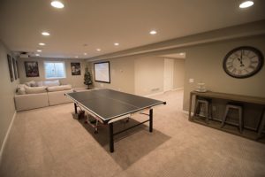 ping pong table in finished basement in brighton michigan with large living room
