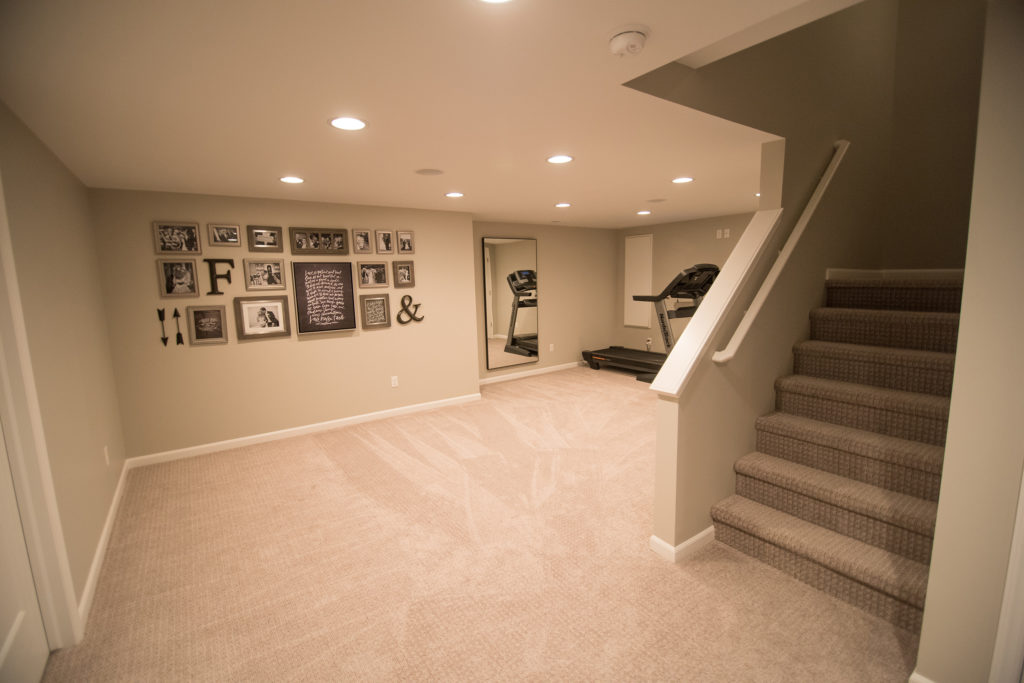 open staircase in basement with exercise room