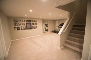 open staircase in basement with exercise room