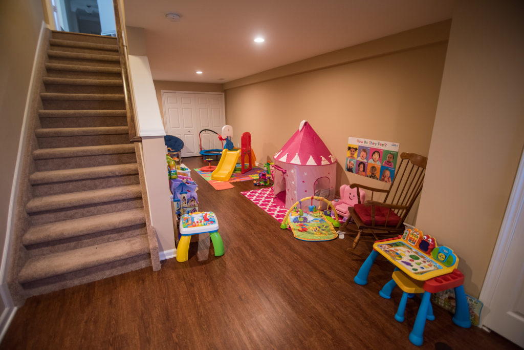 basement playroom for the kids with vinyl plank flooring