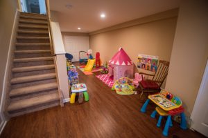basement playroom for the kids with vinyl plank flooring