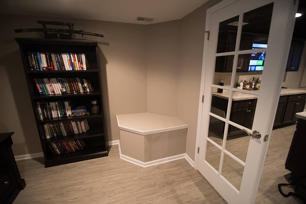 sump pump cover in basement with french doors vinyl plank flooring