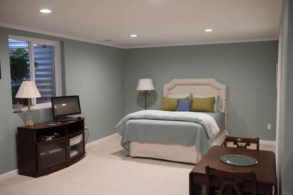 spare bedroom in basement with egress window and bathroom