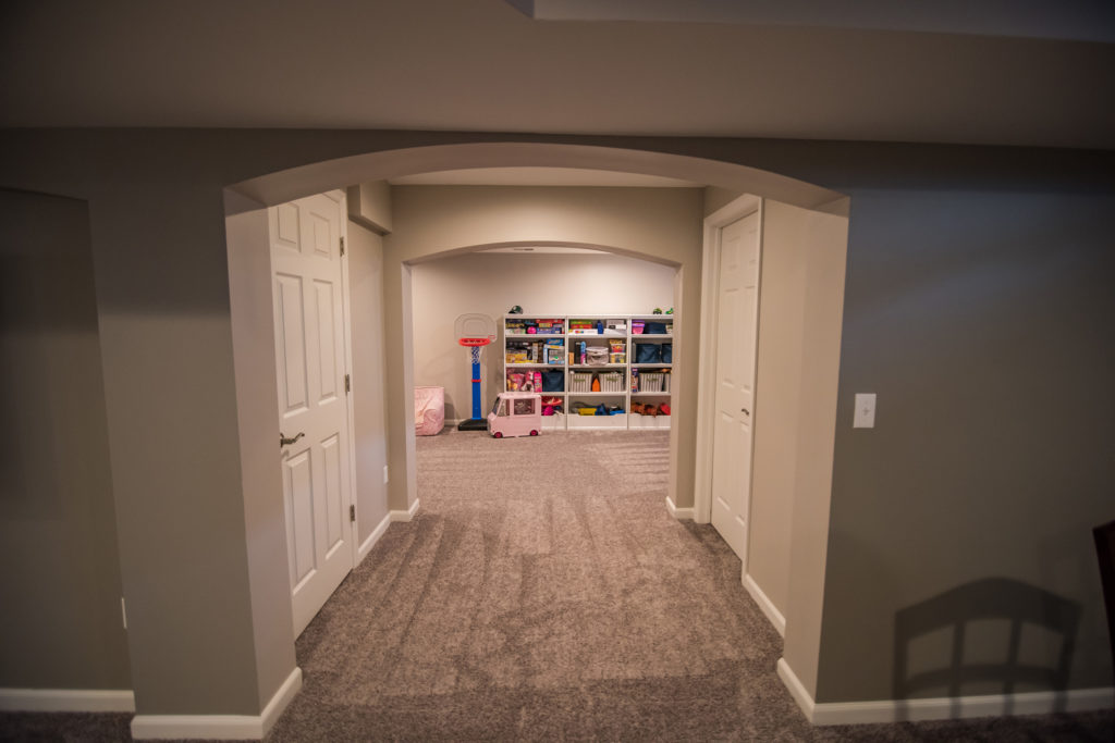 archway in basement design to playroom