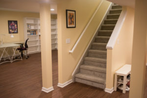 open view staircase into basement with study area behind