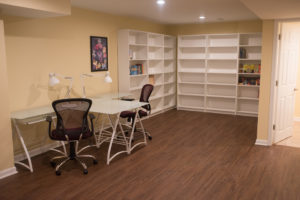 study area in basement for kids with desks and bookshelves