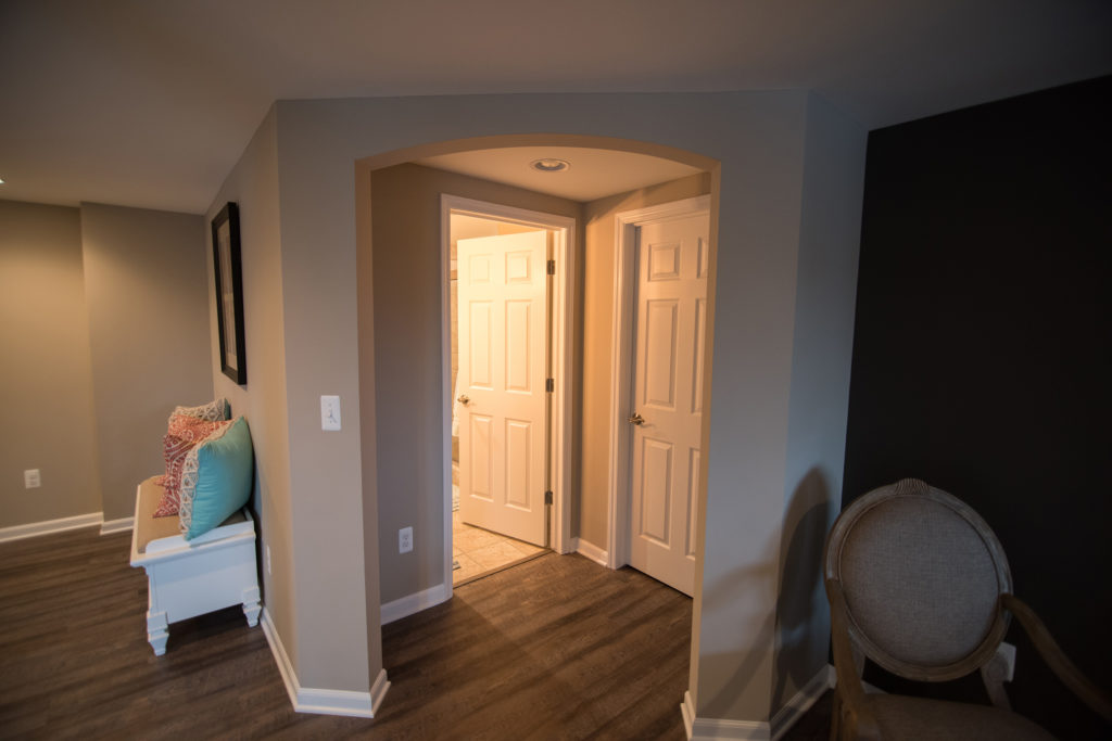 archway in basement hallway into bathroom