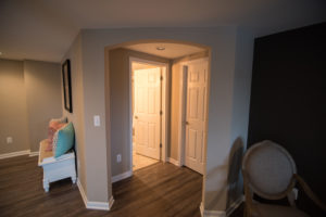 archway in basement hallway into bathroom