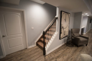 open view staircase with spindles entering basement for welcoming design