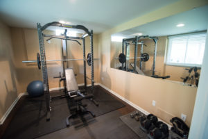 home fitness room in basement with french doors