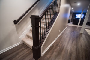 hand rail leading to basement with an open rail design