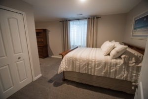 basement bedroom with two beds egress window closet