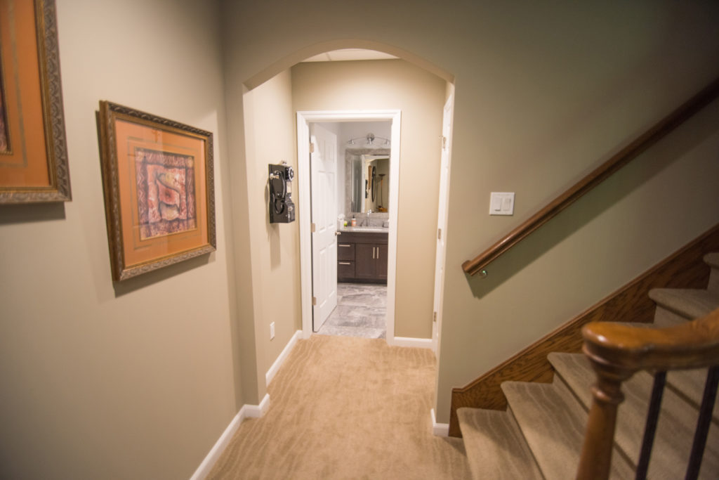 archway in basement leading to bathroom adding a design feature