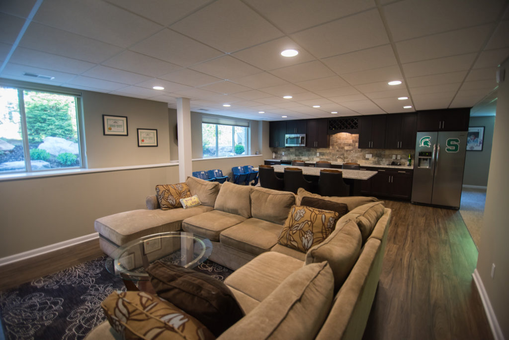basement kitchen with adjacent living room with a large sectional