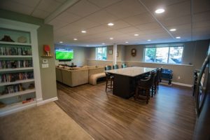 basement kitchen with vinyl plank flooring and a large island with seating