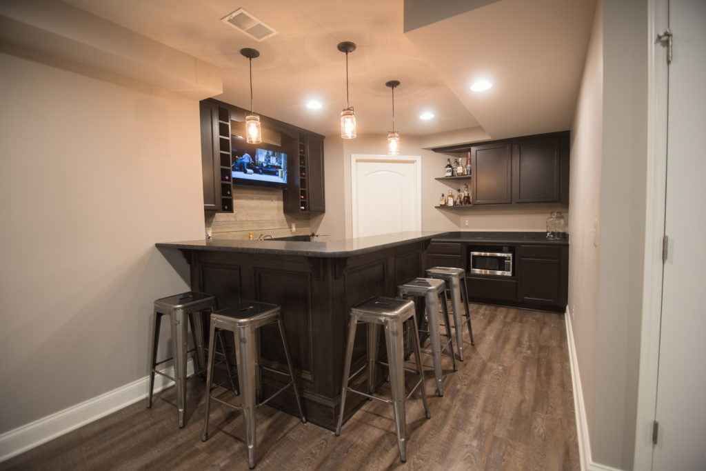 industrial rustic basement bar with metal stools