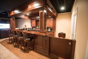 basement bar with soffet and stained wood