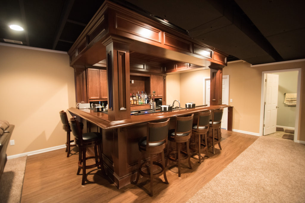decorative pub style bar with wood details and soffet above bar