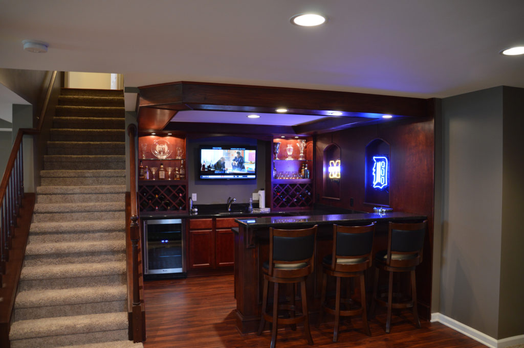finished basement with bar area and led lighting with bar accents