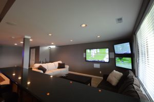 basement living room with granite seating area behind couch