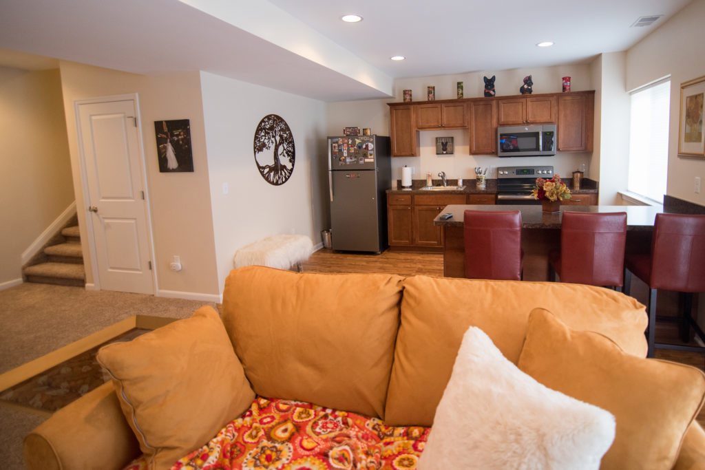 finished basement with large kitchen area and living room