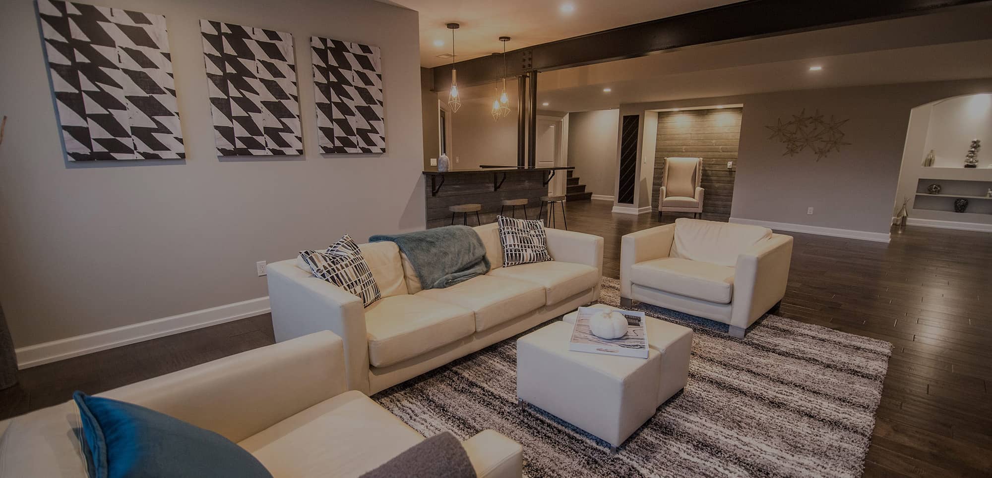 commerce michigan finished basement with dark vinyl plank flooring and grey walls with industrial design