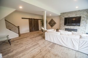 stained staircase railing leading to basement living room
