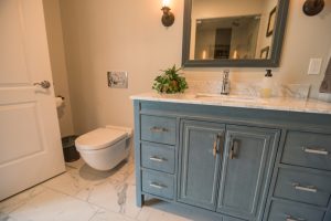 blue vanity in tiled bathroom for a pop of color