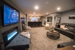 finished basement in south lyon, MI with carpet and fireplace and bar area