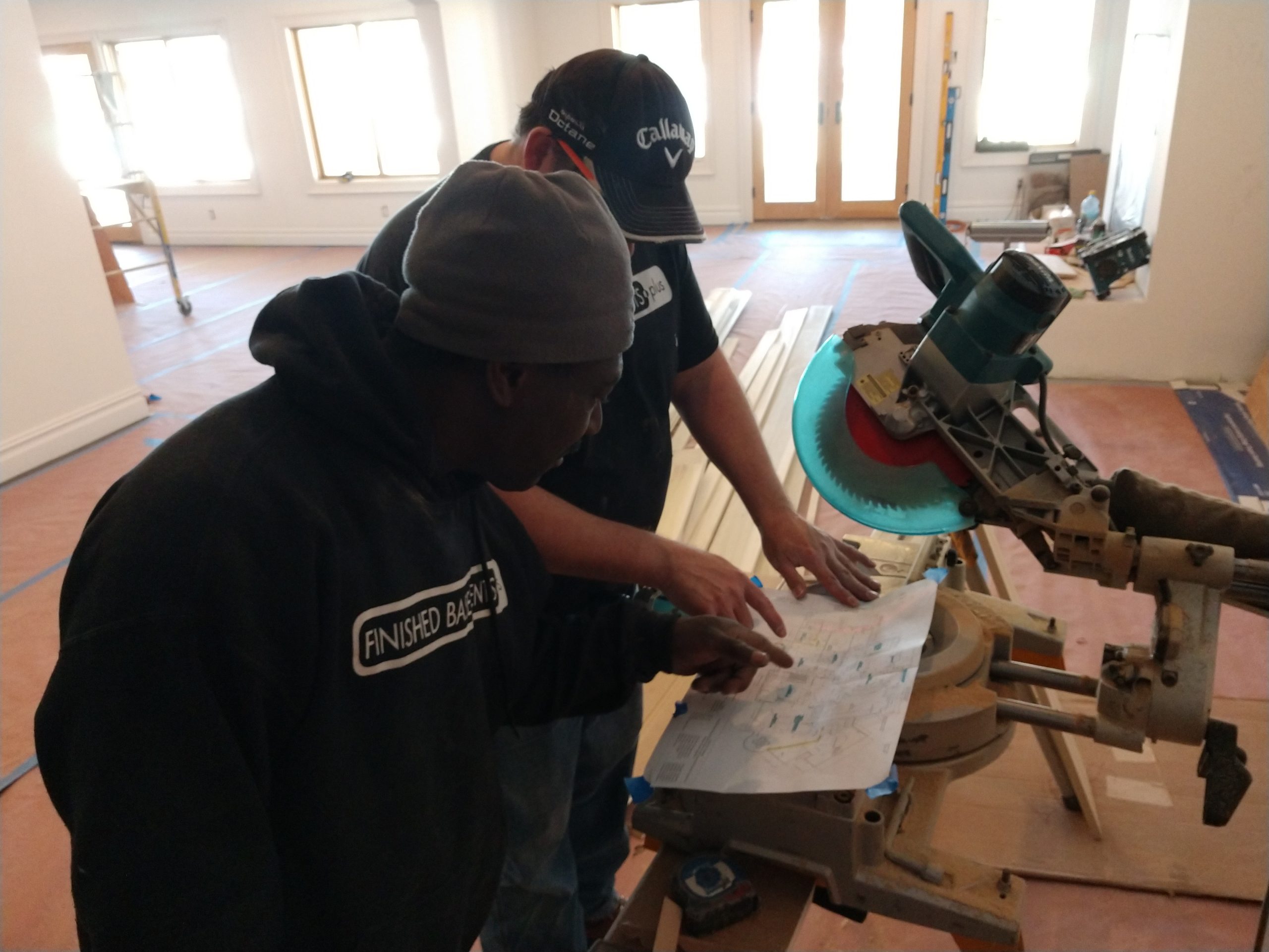 project manager working to install basement working on floorplan