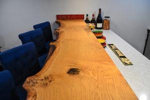Finished basement home bar with custom wood countertop in Farmington Hills, Michigan
