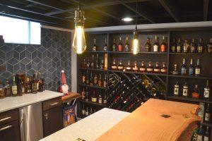 Finished basement home bar with custom wood countertop and wine rack wall in Farmington Hills, Michigan