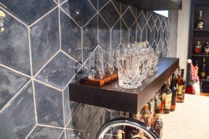 Finished basement home bar with tile backsplash in Farmington Hills, Michigan