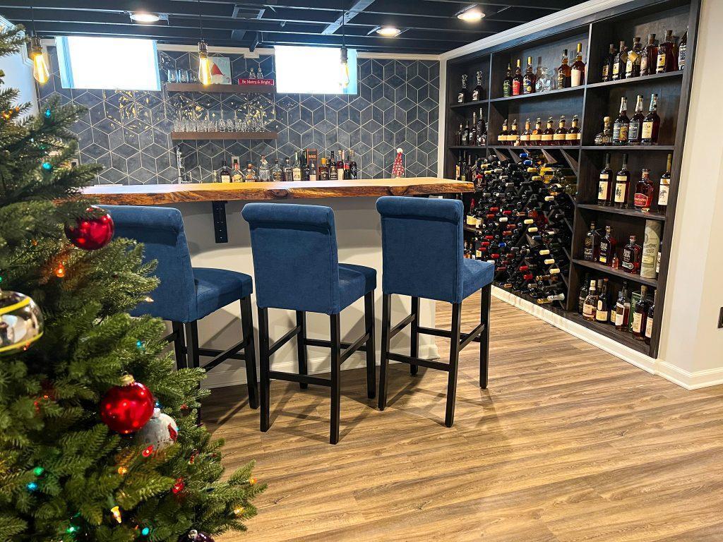 Finished basement home bar with custom wood countertop and wine rack wall in Farmington Hills, Michigan