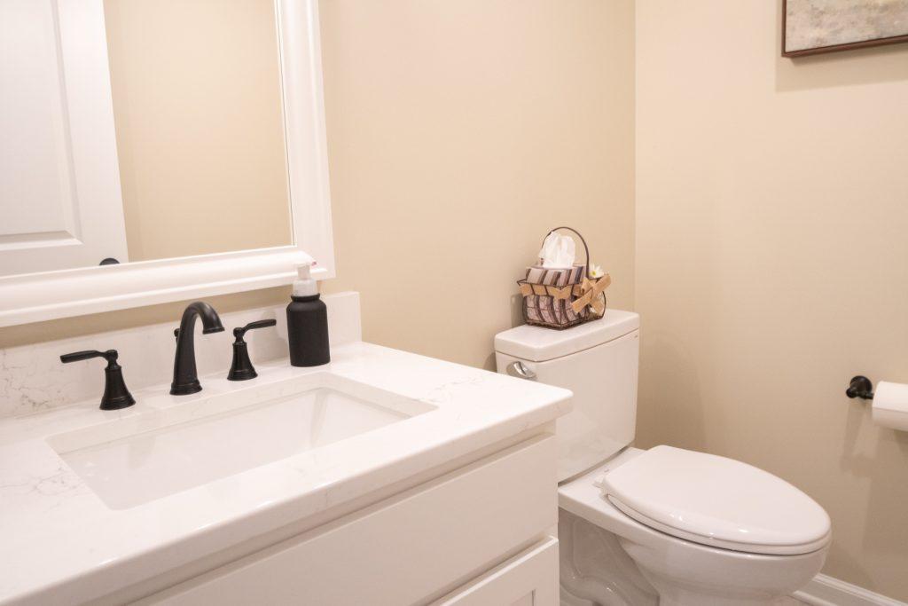 Finished basement bathroom looking at the white vanity and countertop.
