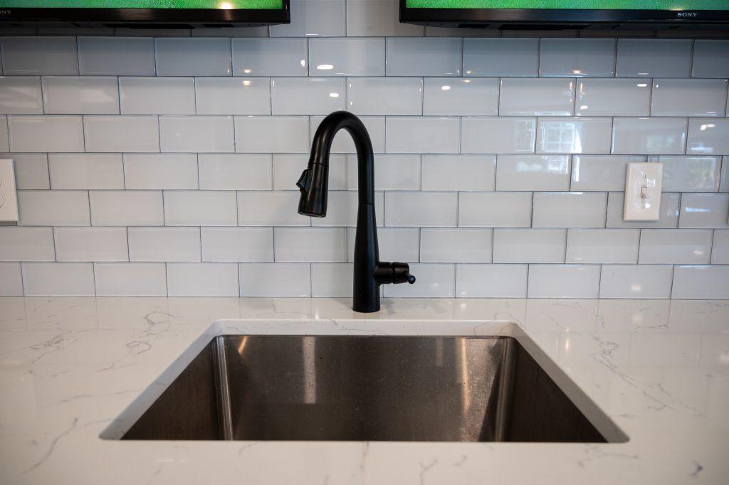 Finished basement bar white backsplash in Northville, Michigan