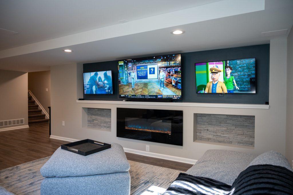Finished basement living room tv wall with niche tile in New Hudson, Michigan