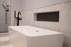 Finished basement bathroom with niche tile and large bathtub in Bloomfield Hills, Michigan