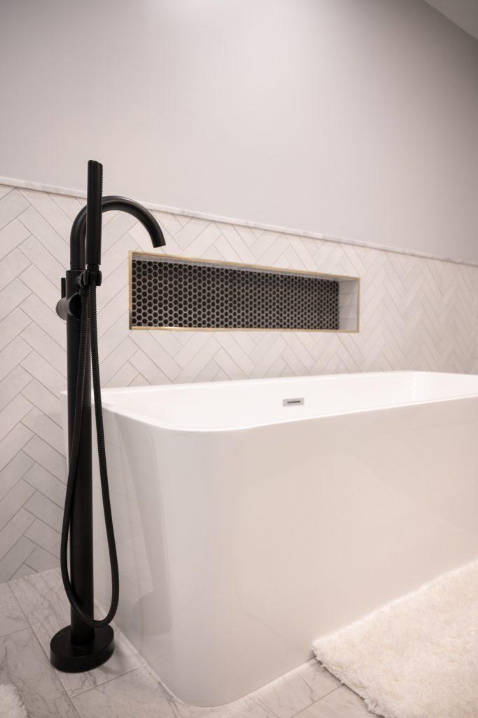 Finished basement bathroom with niche tile and large bathtub in Bloomfield Hills, Michigan