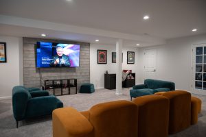 Living room in finished basement with brick backsplash