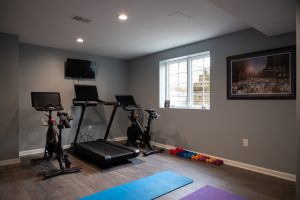 Workout room in finished basement with window for natural light