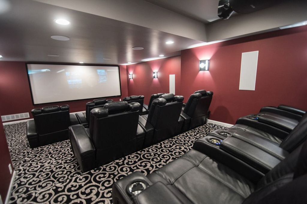 Basement home theater with projector and stadium seating