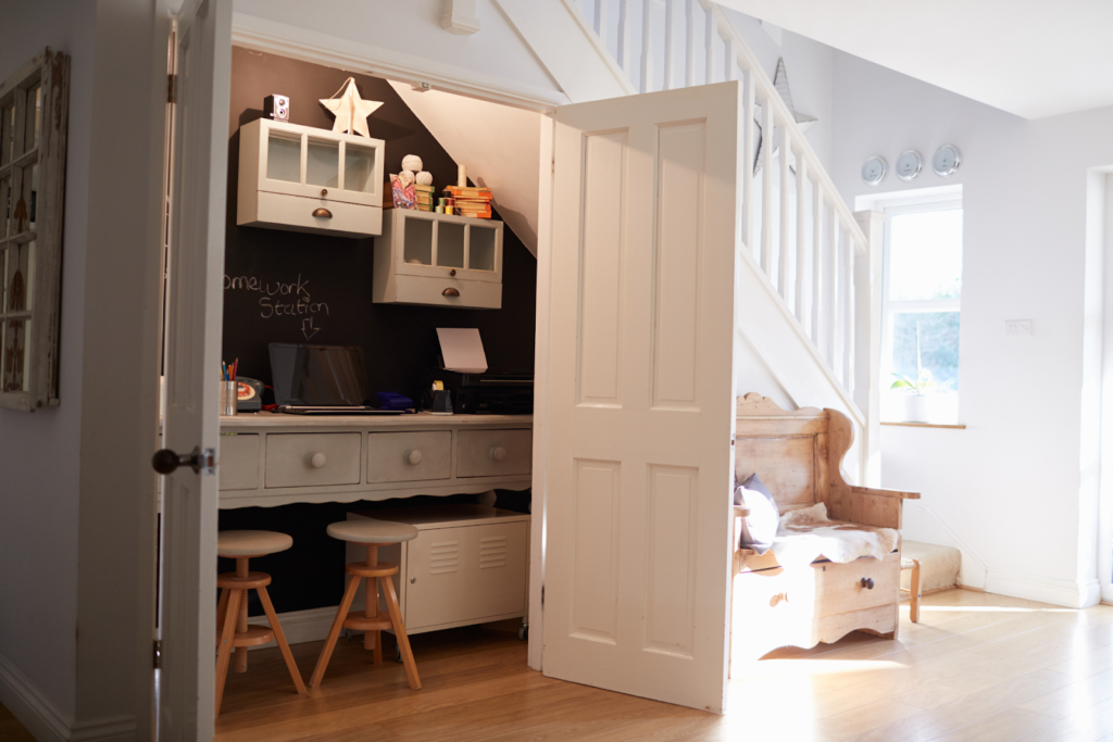 Whimsical kids’ playroom with colorful décor beneath staircase