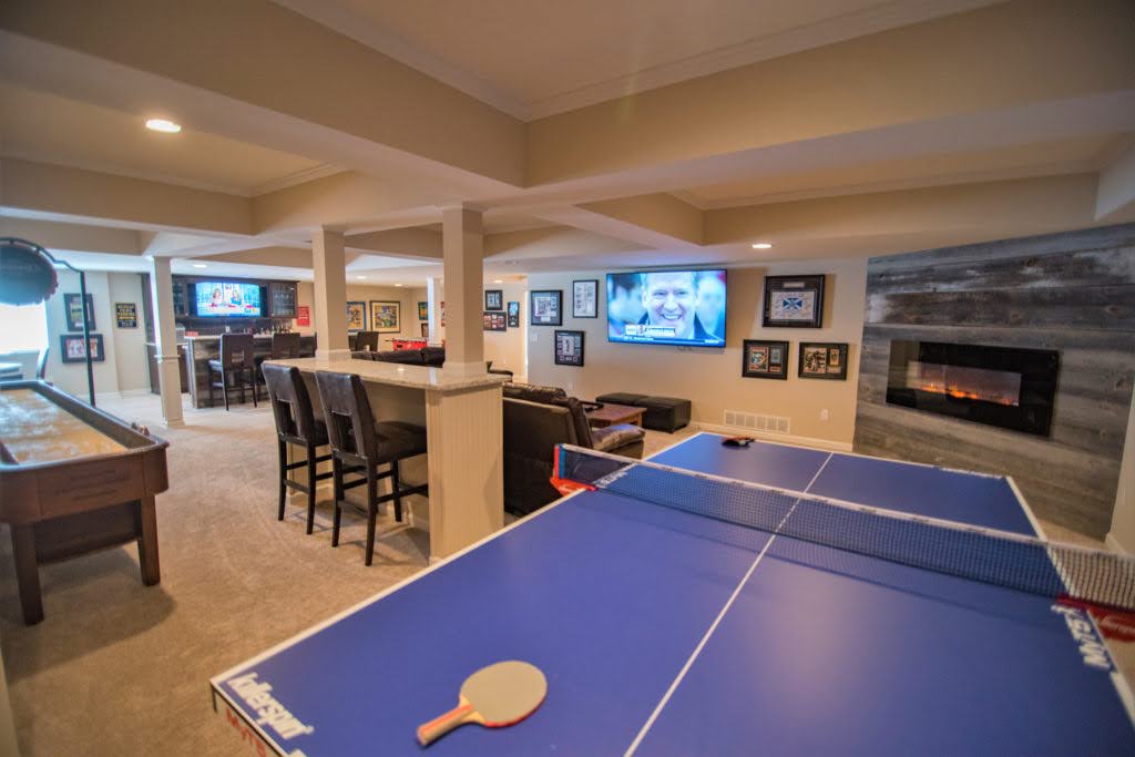 Finished basement featuring sports-themed man cave design